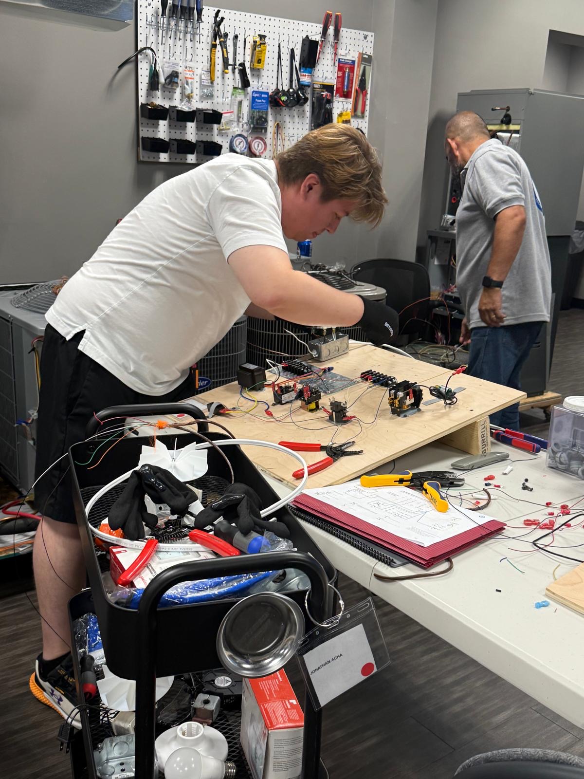 Student working on electrical training board