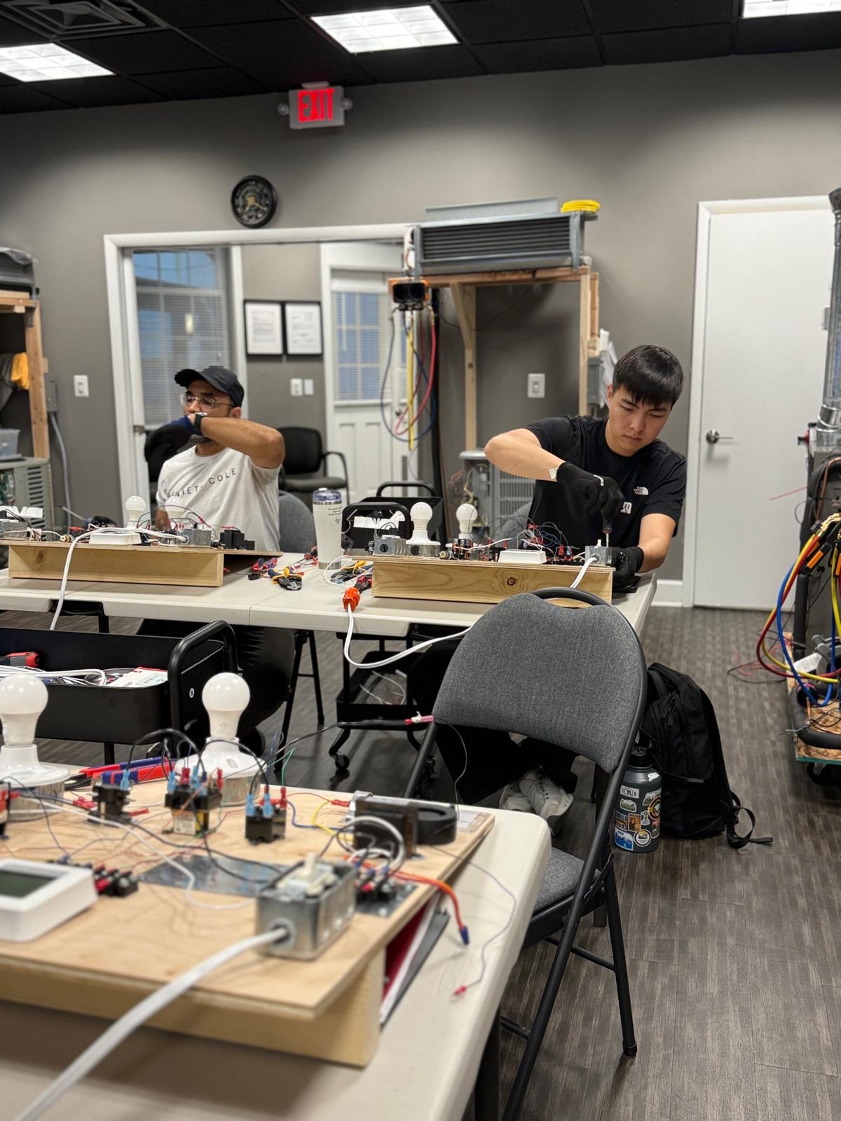 Students building HVAC training boards